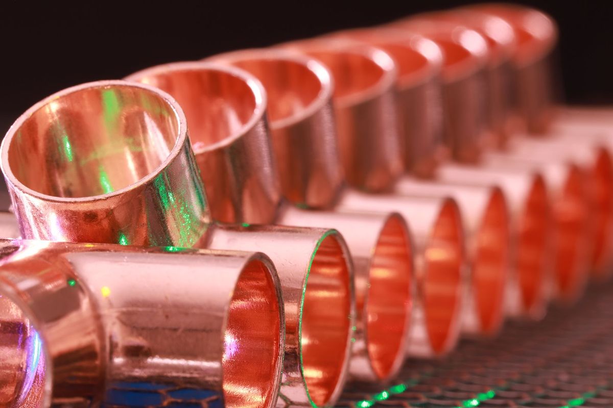 A row of copper pipe fittings